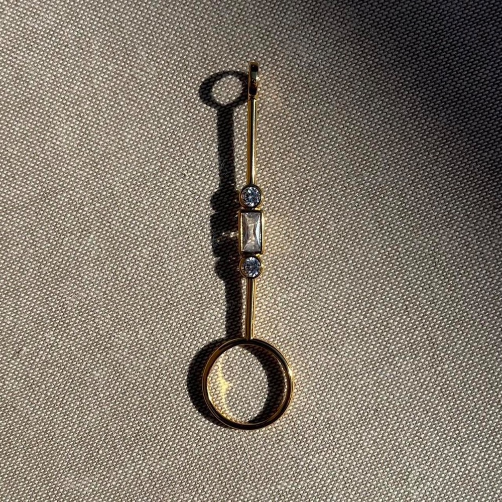 Gold plated cigarette holder (or joint holder) ring with clear stones.